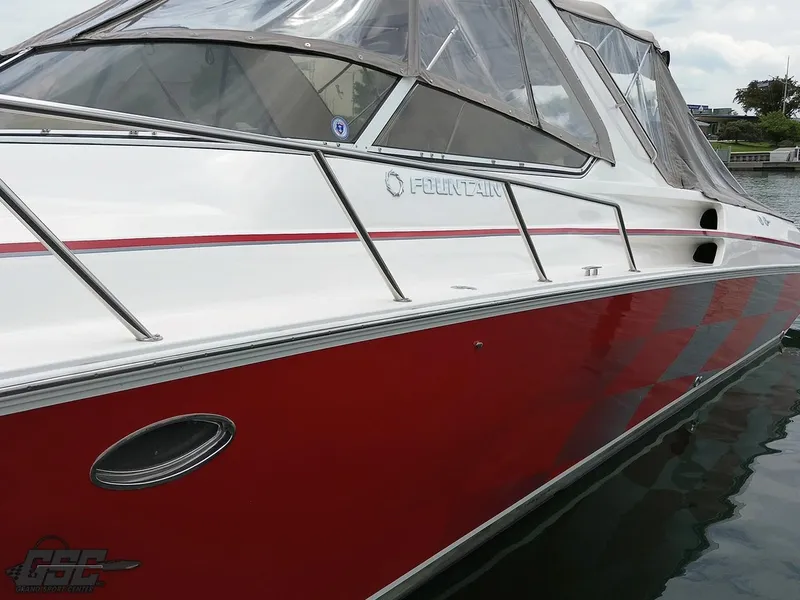 Slide: The Image of 2006 Fountain 48 Express Cruiser with red and white exterior on water. - 7