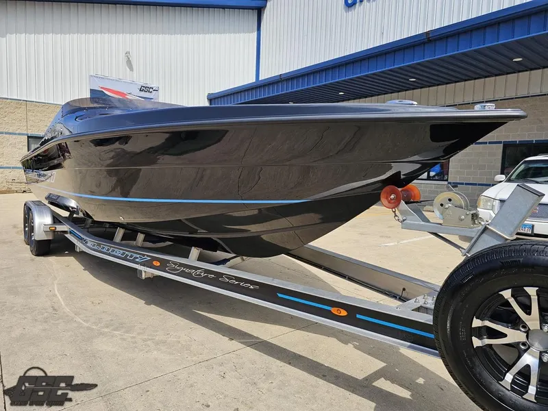 Slide: The Image of 2022 Velocity 290SC Signature Series boat on trailer, sleek black design, parked outdoors. - 15