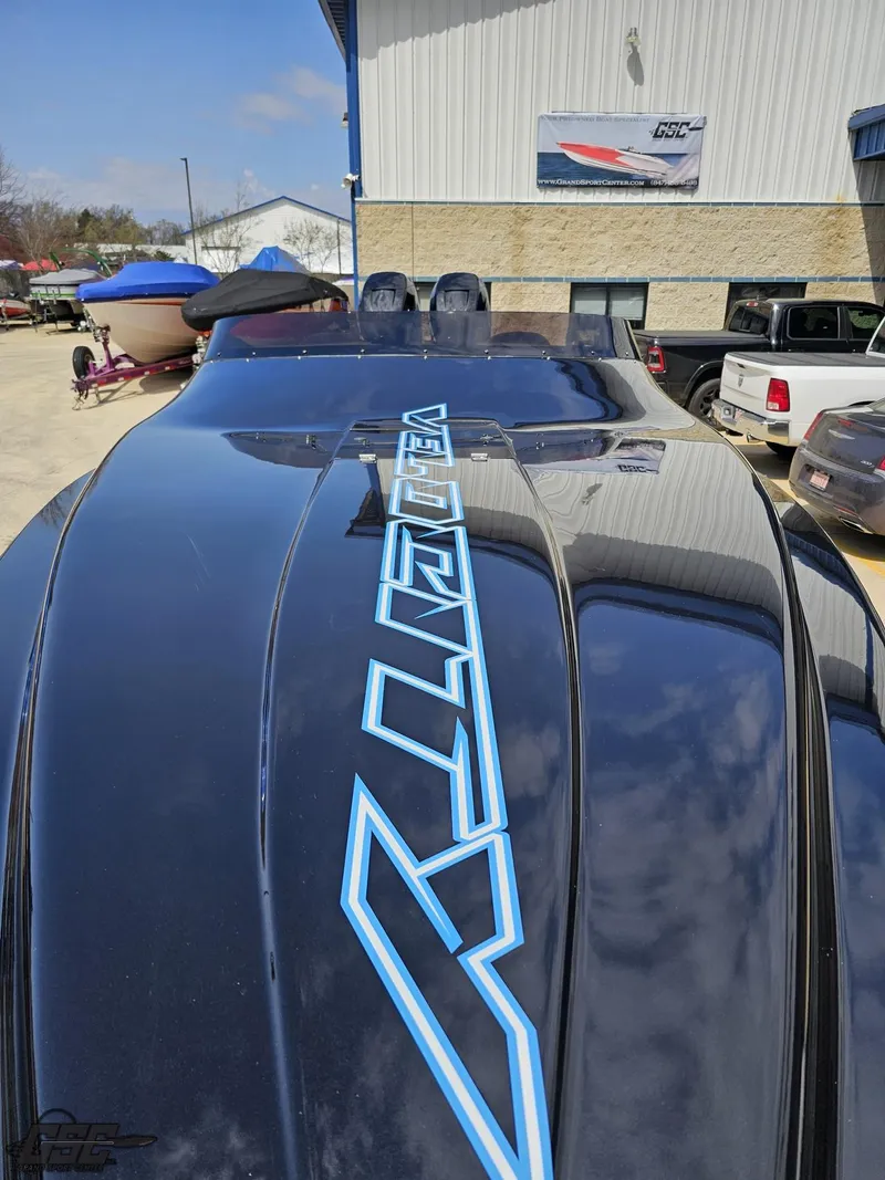 Slide: The Image of 2022 Velocity 290SC Signature Series boat with sleek black design and blue logo detailing. - 17