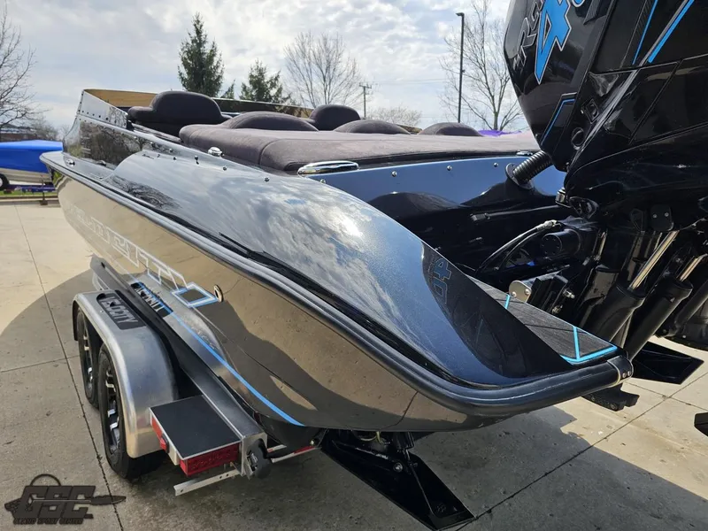 Slide: The Image of 2022 Velocity 290SC Signature Series boat on trailer, sleek design, powerful engine, outdoor setting. - 28