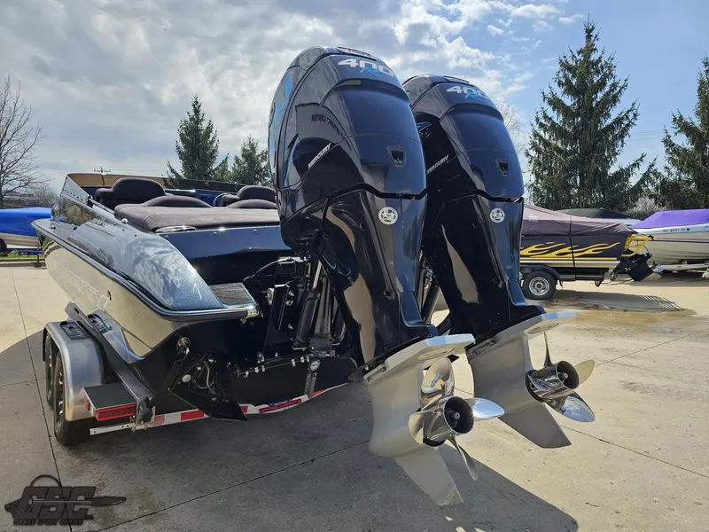 Slide: The Image of 2022 Velocity 290SC Signature Series boat with dual outboard motors on a trailer. - 30