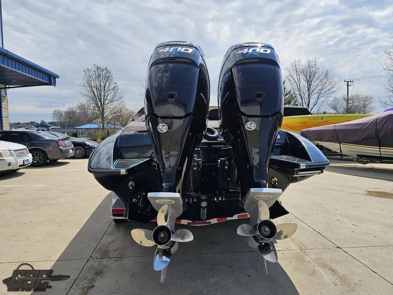 Slide: The Image of 2022 Velocity 290SC Signature Series boat with dual outboard motors, parked outdoors. - 31