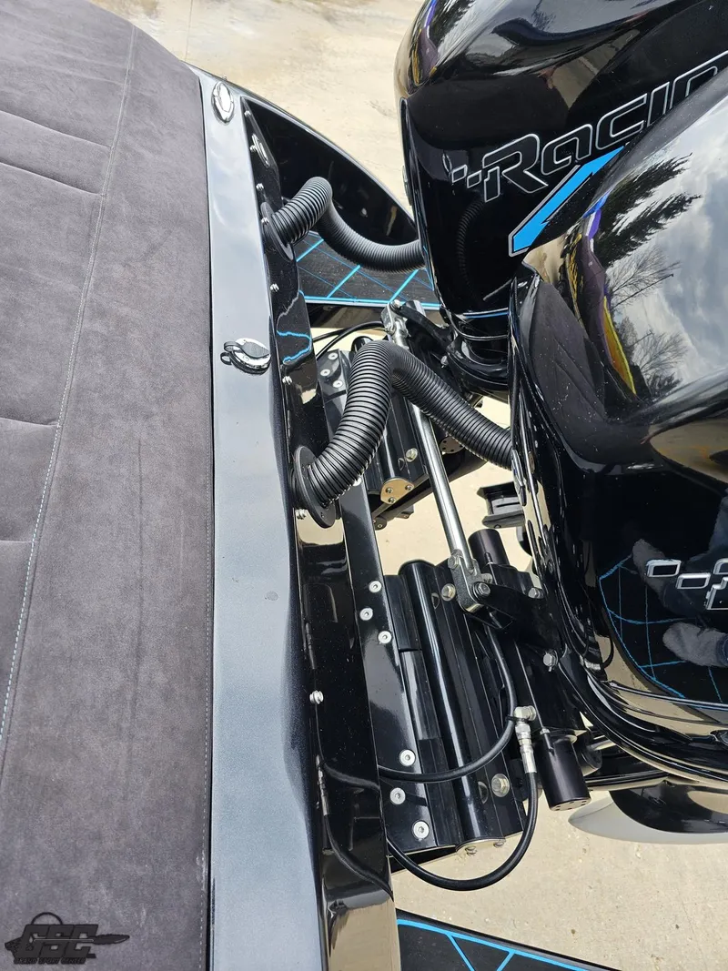 Slide: The Image of 2022 Velocity 290SC Signature Series boat engine detail with sleek black design. - 36