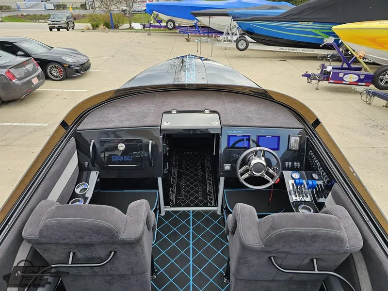 Slide: The Image of 2022 Velocity 290SC Signature Series boat interior with modern dashboard and seating. - 42