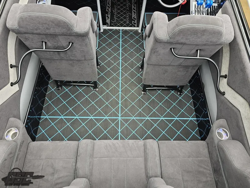 Slide: The Image of Interior of 2022 Velocity 290SC Signature Series boat with gray seating and patterned flooring. - 43