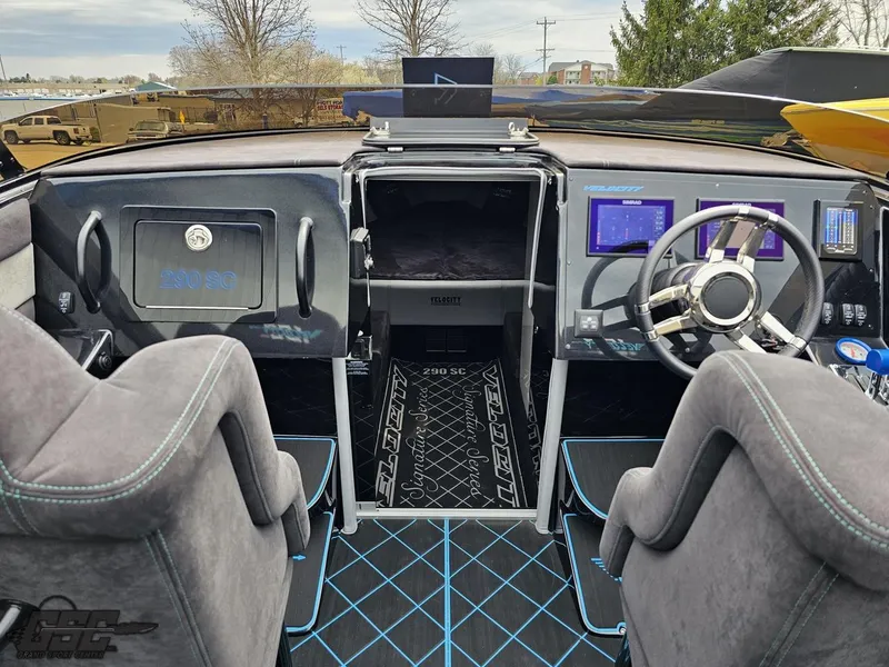 Slide: The Image of 2022 Velocity 290SC Signature Series boat cockpit with modern controls and plush seating. - 44