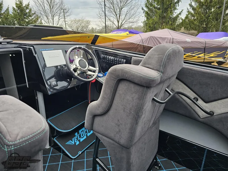 Slide: The Image of Interior of a 2022 Velocity 290SC Signature Series boat with modern dashboard and seating. - 49