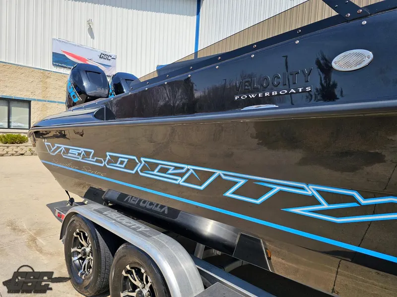 Slide: The Image of 2022 Velocity 290SC Signature Series powerboat on trailer, showcasing sleek design and branding. - 5