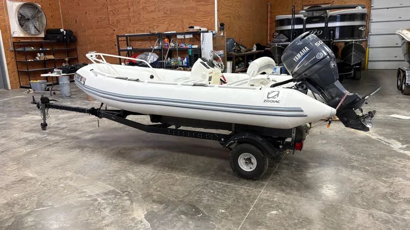 Slide: The Image of 2002 Zodiac Yachtline 420 Deluxe inflatable boat on trailer in a garage setting. - 14
