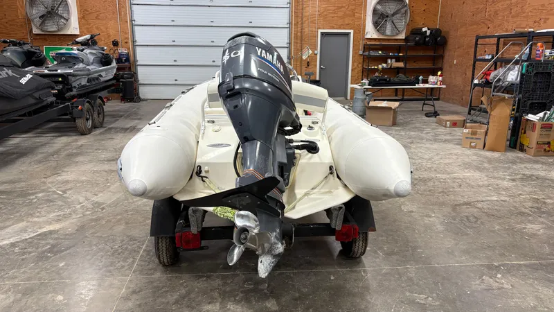Slide: The Image of 2002 Zodiac Yachtline 420 Deluxe inflatable boat with Yamaha outboard motor in a garage. - 15