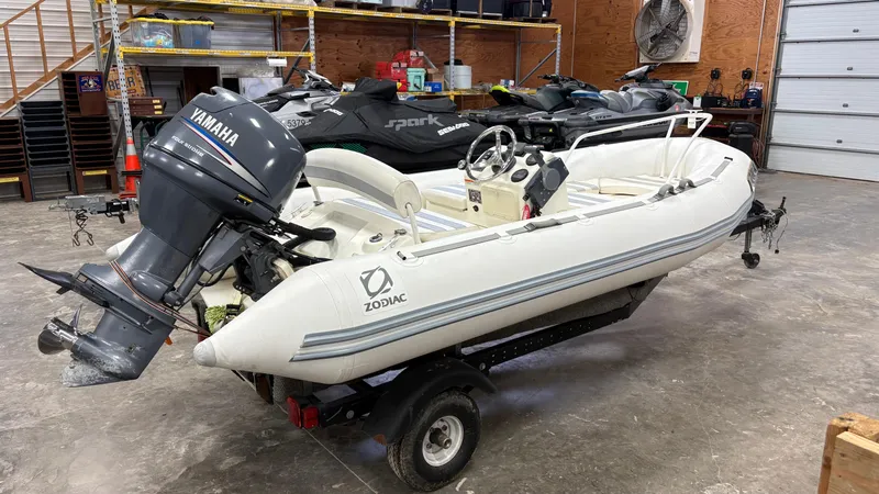 Slide: The Image of 2002 Zodiac Yachtline 420 Deluxe boat with Yamaha engine in a garage setting. - 18