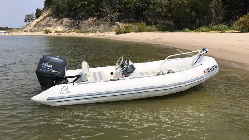 Slide: The Image of 2002 Zodiac Yachtline 420 Deluxe inflatable boat on calm water. - 2