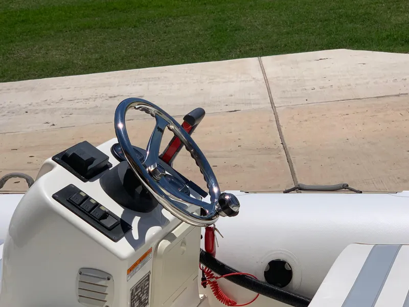 Slide: The Image of 2002 Zodiac Yachtline 420 Deluxe steering console with chrome wheel and control panel. - 4