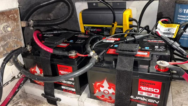 Slide: The Image of Batteries and charger setup in a 2002 Zodiac Yachtline 420 Deluxe boat. - 8