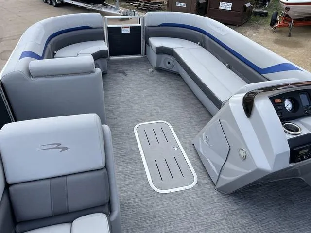 Slide: The Image of 2020 Bennington 22 SLX pontoon boat interior with gray seating and modern dashboard. - 10