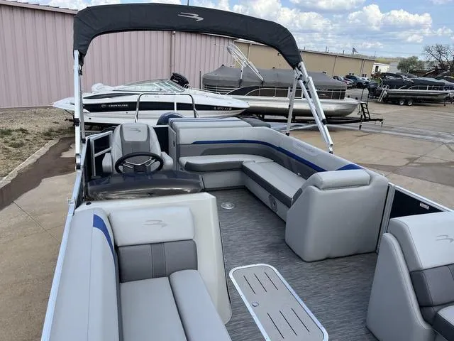 Slide: The Image of 2020 Bennington 22 SLX pontoon boat with spacious seating and sleek design, docked outdoors. - 13