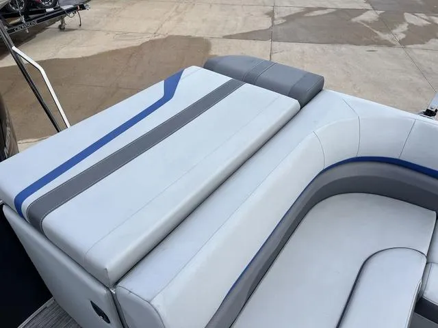 Slide: The Image of 2020 Bennington 22 SLX boat seating with gray and blue upholstery on a dock. - 15