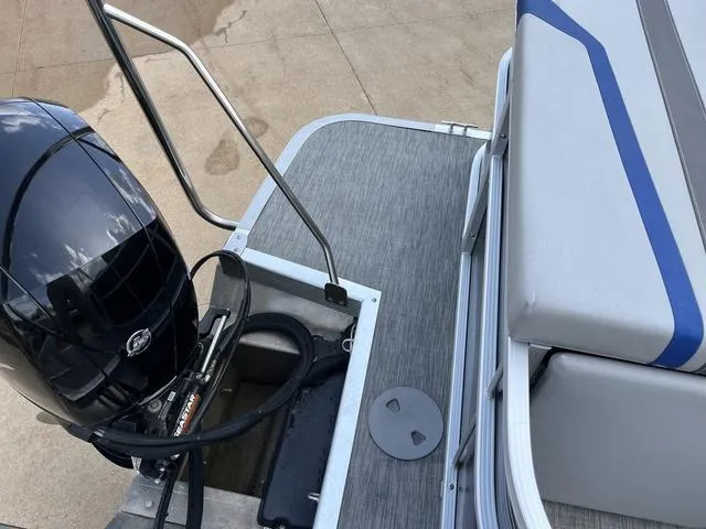 Slide: The Image of 2020 Bennington 22 SLX boat with outboard motor and cushioned seating. - 17