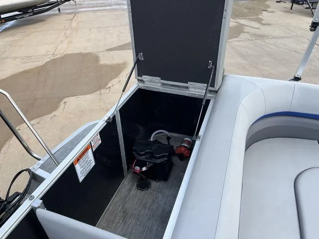 Slide: The Image of 2020 Bennington 22 SLX boat storage compartment with open lid, revealing interior details. - 18