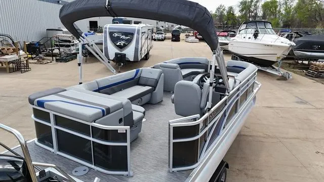 Slide: The Image of 2020 Bennington 22 SLX pontoon boat with spacious seating and canopy, docked at a marina. - 4