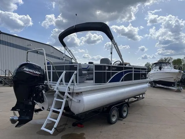Slide: The Image of 2020 Bennington 22 SLX pontoon boat with Mercury engine on trailer, parked outdoors. - 7