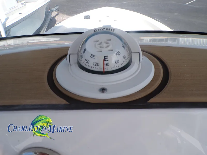 Slide: The Image of Compass on 2023 NauticStar 227 XTS boat dashboard, Charleston Marine logo visible. - 11