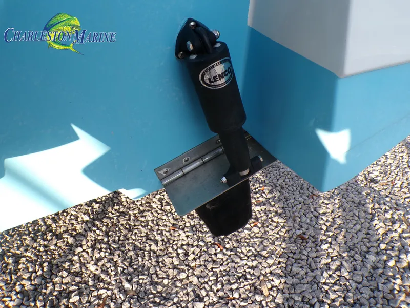 Slide: The Image of 2023 NauticStar 227 XTS boat with Lenco trim tab on gravel surface. - 14