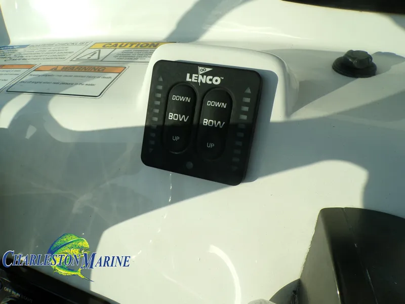 Slide: The Image of 2023 NauticStar 227 XTS Lenco trim tab control panel on boat dashboard. - 15
