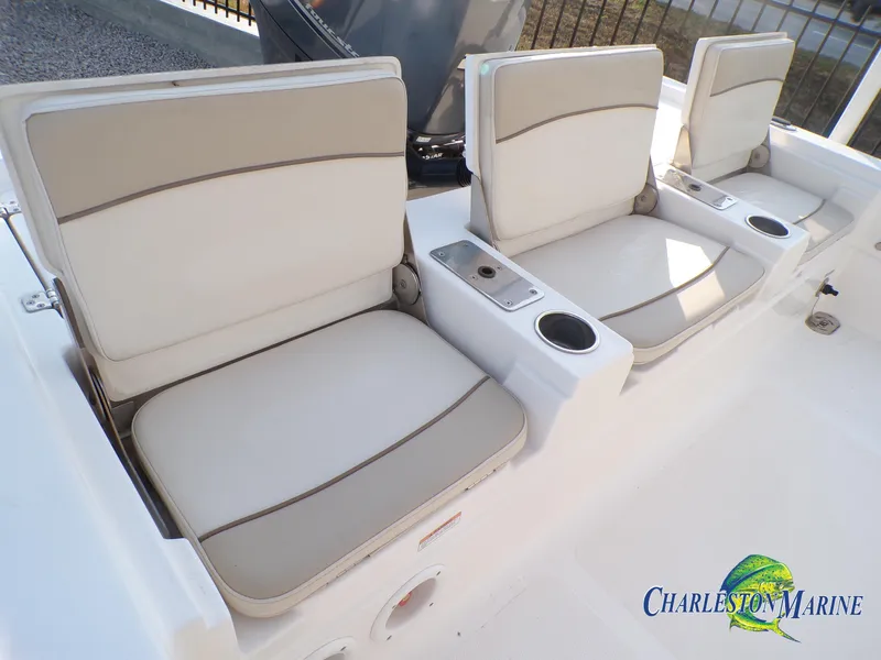 Slide: The Image of 2023 NauticStar 227 XTS boat seats with cup holders, Charleston Marine logo visible. - 20