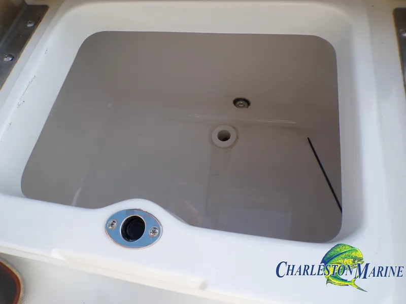 Slide: The Image of 2023 NauticStar 227 XTS livewell with Charleston Marine logo. - 21