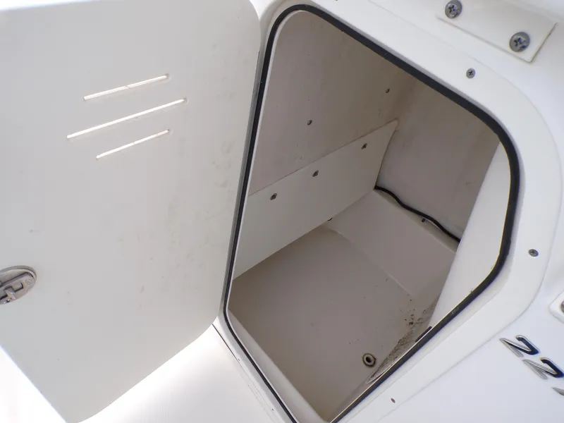 Slide: The Image of Open storage compartment on 2023 NauticStar 227 XTS boat. - 23
