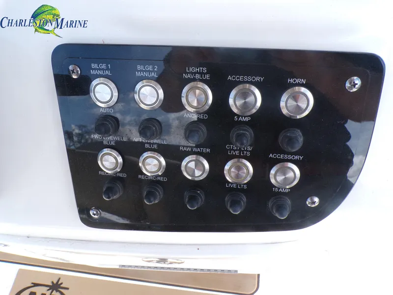 Slide: The Image of Control panel of 2023 NauticStar 227 XTS boat with various switches and buttons. - 25