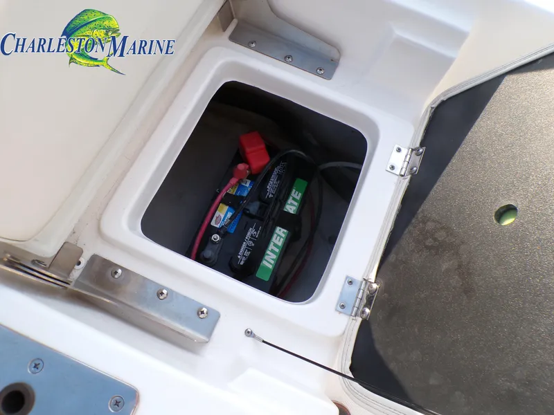 Slide: The Image of 2023 NauticStar 227 XTS boat battery compartment with Charleston Marine logo. - 26