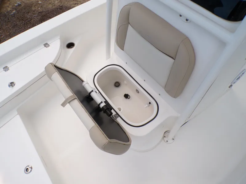 Slide: The Image of 2023 NauticStar 227 XTS boat interior with open storage compartment and seating. - 30