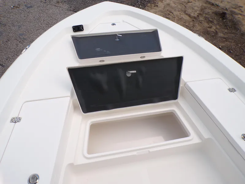 Slide: The Image of 2023 NauticStar 227 XTS boat storage compartments and deck view. - 31
