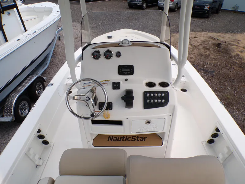 Slide: The Image of 2023 NauticStar 227 XTS boat console with steering wheel and controls. - 34