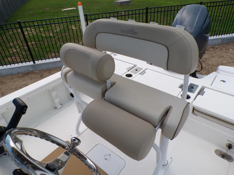 Slide: The Image of 2023 NauticStar 227 XTS boat interior with beige seating and steering wheel. - 35