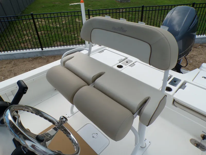 Slide: The Image of 2023 NauticStar 227 XTS boat interior with beige seating and steering wheel. - 36