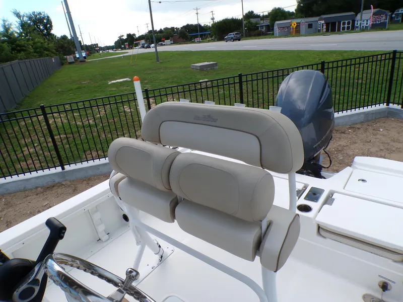 Slide: The Image of 2023 NauticStar 227 XTS boat interior with beige seating and steering wheel. - 37