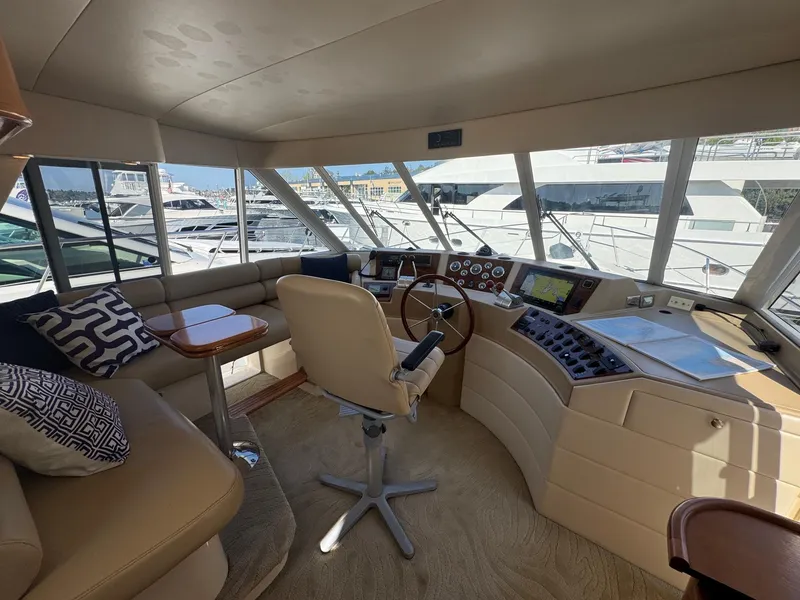 Slide: The Image of Pilothouse interior of 2004 Meridian 490, featuring helm, seating, and panoramic windows. - 10