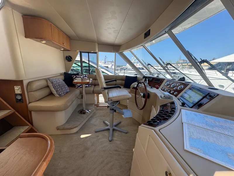 Slide: The Image of Luxurious 2004 Meridian 490 Pilothouse interior with helm, seating, and navigation equipment. - 11
