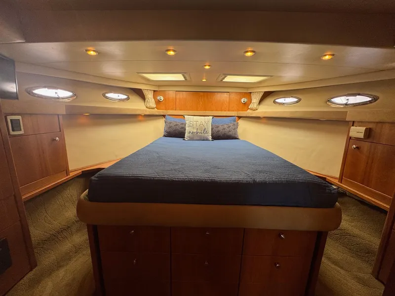Slide: The Image of Luxurious 2004 Meridian 490 Pilothouse bedroom with elegant lighting and cozy bedding. - 15