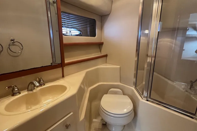 Slide: The Image of Bathroom interior of 2004 Meridian 490 Pilothouse yacht with sink, toilet, and shower. - 17