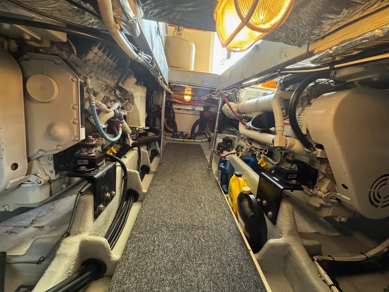 Slide: The Image of Engine room of a 2004 Meridian 490 Pilothouse yacht, showcasing mechanical components and systems. - 21