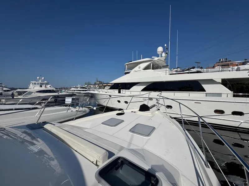 Slide: The Image of 2004 Meridian 490 Pilothouse yacht docked among other luxury boats under clear blue sky. - 5