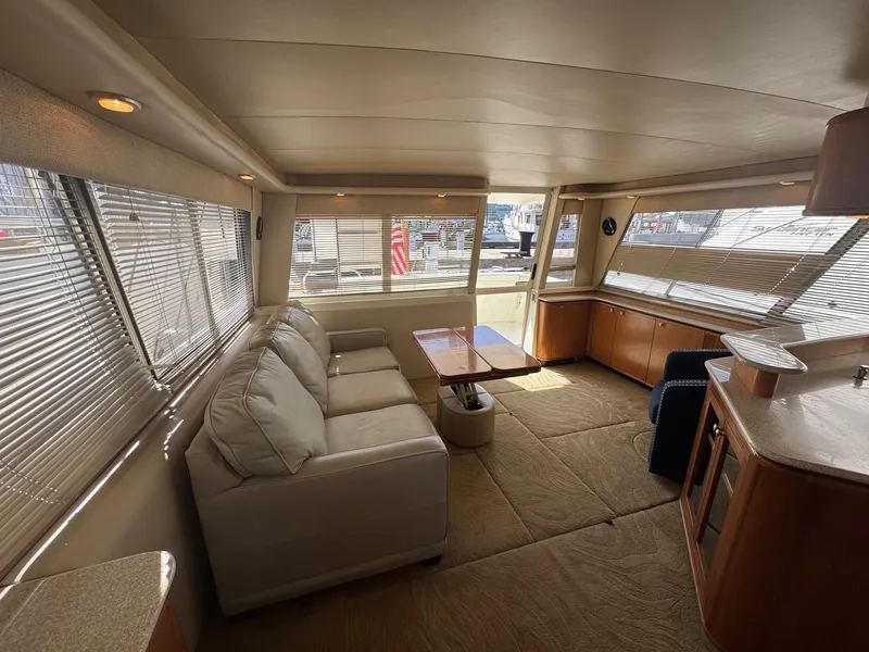 Slide: The Image of Interior of 2004 Meridian 490 Pilothouse yacht with sofa, table, and large windows. - 8