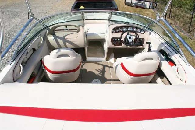 Slide: The Image of Interior view of 2000 Chaparral 186 SSi boat, featuring white and red seating. - 5
