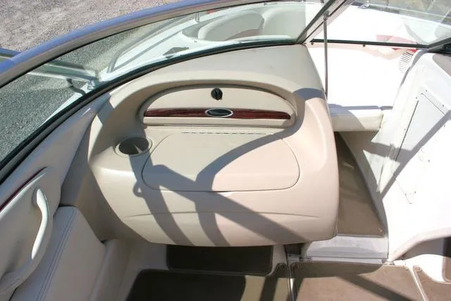 Slide: The Image of Interior of 2000 Chaparral 186 SSi boat, featuring beige dashboard and seating area. - 9