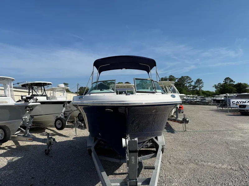 Slide: The Image of 2024 Robalo R207 Dual Console boat on trailer, displayed outdoors under clear sky. - 11