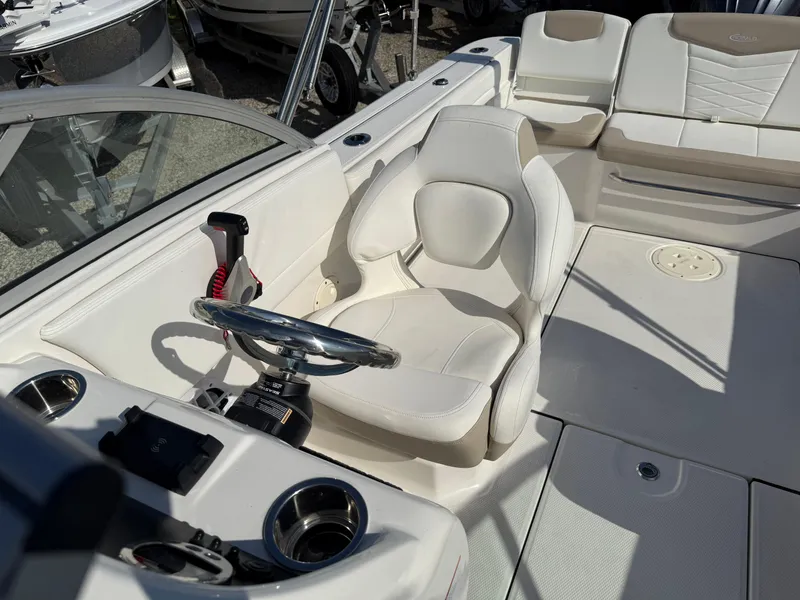 Slide: The Image of 2024 Robalo R207 Dual Console boat interior with steering wheel and seating. - 15